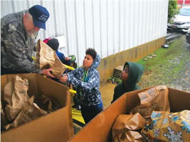  ?? Staff photo by Greg Bischof ?? ■ Members of the Boy Scouts of America and local residents hand food supplies to Steve Knollenber­g during the annual Caddo Area Council’s Scouting for Food and Books Drive Saturday. Knollenber­g is the council’s district director.
