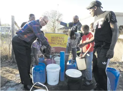  ?? Picture: Alex Matlala ?? ON TAP. Limpopo Premier Stanley Mathabatha assists thirsty residents of Giyani. They asked Mathabatha to intervene in a payment squabble.