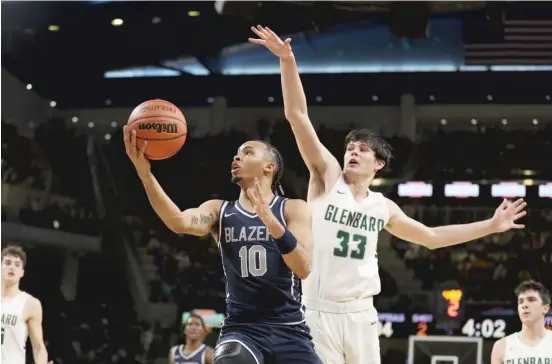  ?? KIRSTEN STICKNEY/SUN-TIMES ?? Chicago native Amari Bailey, who played high school ball in California, takes the ball to the basket against Glenbard West last month at Wintrust Arena.