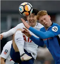  ?? Reuters ?? Tottenham’s Son Heung-min (left) and Rochdale’s Callum Camps clash for the ball during the FA Cup fifth-round match. —