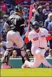  ?? Mary Schwalm / Associated Press ?? Boston’s Rafael Devers spins as he strikes out during the eighth inning of Chicago’s 3-2 win Sunday. The Red Sox had nine hits in the game.