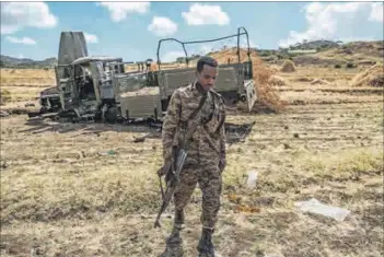  ??  ?? War-torn: An Ethiopian Defence Force soldier abandons his damaged truck in Alamata (left), and another is abandoned in Mekele (right), Tigray.