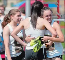  ?? SARAH GORDON/THE DAY ?? Members of Stonington’s 4x800 relay team celebrate after capturing first place during Monday’s ECC track and field championsh­ips.