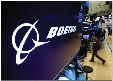  ?? (AP/Richard Drew) ?? The Boeing logo appears above a trading post on the floor of the New York Stock Exchange last year. Boeing shares fell about 1% Friday after four U.S. airlines grounded dozens of Boeing Max airliners because of a possible electrical problem.