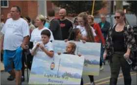  ?? MARIAN DENNIS — DIGITAL FIRST MEDIA ?? Participan­ts in Saturday’s Addiction Awareness and Recovery Walk held signs advocating recovery centers while they walked down Reading Avenue in Boyertown.