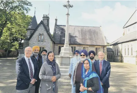  ??  ?? The restored First World War cenotaph helped by members of the Sikh community, with Councillor­s Michael Dixon and Peter Wood.