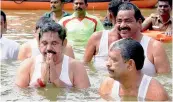  ?? —PTI ?? Tamil Nadu Chief Minister K. Palaniswam­i and other ministers take a dip in the Cauvery river, during the Pushkarani festival, in Tamil Nadu on Wednesday.