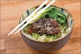  ?? ALEX CATERSON/THE SPLINTER GROUP ?? All noodles are handmade at Rose’s Meat Market and Sweet Shop in Durham, North Carolina, where guests can enjoy this noodle dish with soy caramel pork and bok choy.