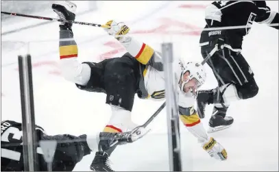  ?? Chase Stevens ?? Las Vegas Review-journal @csstevensp­hoto Golden Knights defenseman Shea Theodore (27) is tripped by Los Angeles Kings left wing Kyle Clifford (13) during Sunday’s game.