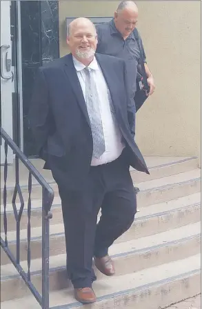  ?? Herald file photo ?? Michael Elphicke leaves the Penticton courthouse during his trial last year.