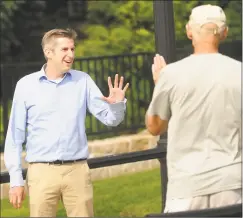  ??  ?? James Maroney, the Democratic candidate for state Senate in District 14, greets a voter at the Founders Walk, a project he envisioned and raised money to fund, in Milford on Thursday.