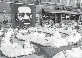  ?? Jim Mone / Associated Press ?? Mourners continue to leave flowers to honor George Floyd in this Feburary photo from George Floyd Square, sacred space reflecting a tragedy that changed the world.