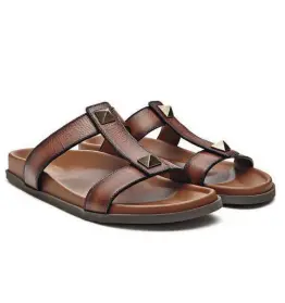  ??  ?? VALENTINO GARAVANI Leather Roman stud slide sandals / € 590