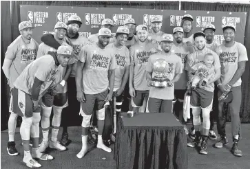  ?? AP Photo/Craig Mitchelldy­er ?? ■ The Golden State Warriors pose with the conference championsh­ip trophy after Game 4 of the Western Conference finals against the Portland Trail Blazers on Monday in Portland, Ore. The Warriors won 119-117 in overtime.