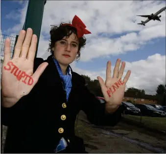  ??  ?? „ Protestor Tilly Gifford dressed as an air stewardess for a Plane Stupid protest against airport expansion.