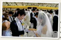  ?? ?? UNIFIED: A mass wedding in Korea. Far left, the late Rev Moon and his wife