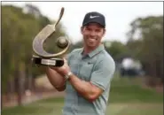  ?? MIKE CARLSON — ASSOCIATED PRESS ?? Paul Casey holds up the champion’s trophy after winning the Valspar Championsh­ip.