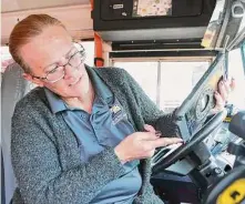  ?? Photos by Jason Fochtman/Staff photograph­er ?? Bus driver Lisa Martinez demonstrat­es Conroe ISD’s new SMART Tag system for bus riders.