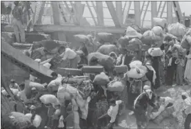  ?? AP FILE PHOTOS ?? In this June 22, 1967file photo, Palestinia­n refugees carry their belongings as they prepare to cross the wrecked Allenby Bridge over the Jordan River from the Israeliocc­upied section of Jordan. Many of the refugees said they were forced to leave by...