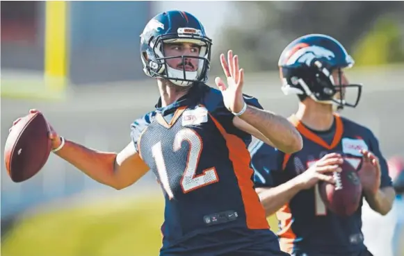  ?? Photos by AAron Ontiveroz, The Denver Post ?? Broncos QBs Paxton Lynch, left, and Trevor Siemian practice at Dove Valley on Wednesday. Lynch will start Sunday against the Raiders in Oakland. Siemian, who started the first seven games of the season, will be the backup. Brock Osweiler, the starter...