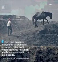  ?? AFP ?? A worker walks his horse after dumping waste from brass factories on the banks of the Ramganga river in Moradabad. —