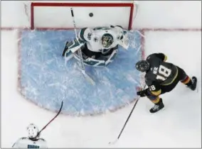  ?? THE ASSOCIATED PRESS ?? Vegas Golden Knights left wing James Neal (18) scores on San Jose Sharks goaltender Aaron Dell (30) during the third period of Game 1, Thursday in Las Vegas. The Golden Knights won 7-0.