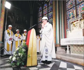  ?? Karine Perret / AFP / Getty Images ?? Archbishop of Paris Michel Aupetit leads the first Mass in a side chapel Saturday, two months to the day after a devastatin­g fire engulfed the Notre Dame Cathedral in Paris that shocked France and the world.