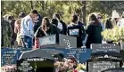  ??  ?? Family and friends gather at the grave of 12-year-old Meadow James, who died in a car crash near Palmerston North.