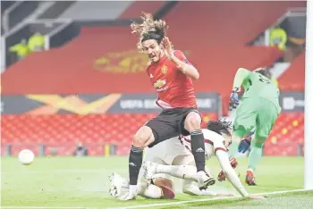  ?? — AFP photo ?? Roma’s Chris Smalling brings down Manchester United’s Edinson Cavani in the penalty area which a er a VAR review is given as a penalty during the UEFA Europa League semi-final, first leg match at Old Trafford stadium in Manchester, north west England.