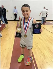  ?? SUBMITTED ?? Jaxon Ramos, of Lorain, stands on Feb. 18with his state championsh­ip trophy for the Elks Hoop Shoot.