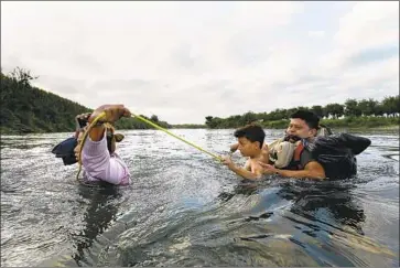  ?? Carolyn Cole Los Angeles Times ?? MIGRANTS cross the Rio Grande in June. A new U.S. rule ending asylum claims at the southern border would most directly affect Central Americans, who account for most of a recent surge in migrant arrivals.