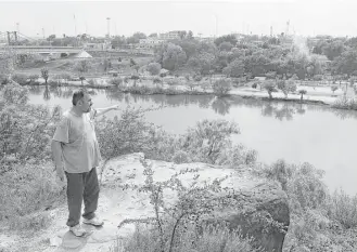  ?? JERRY LARA / San Antonio Express-News ?? Jaime Salinas, 45, reminisces about the Roma Bluffs, where he played as a child. The next round of border wall building includes 8 miles in western Starr County, an area that might include Roma.