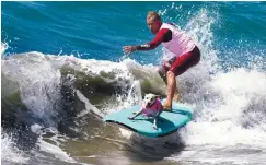  ??  ?? Surf dog Bakio competes in the tandem event during the 9th annual Surf City Surf Dog event at Huntington Beach, California on Saturday. Dogs, big and small, and some in tandem braved the large swell that greeted them during the iconic event at Surf...