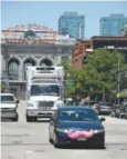  ?? Andy Cross, Denver Post file ?? Amustachio­ed Lyft driver heads up 17th Street to pick up a client in June.