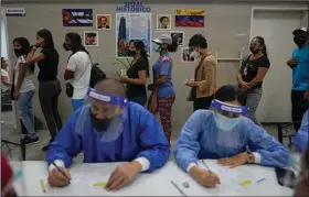  ?? (AP/Ariana Cubillos) ?? People line up to receive a dose of the Sinopharm covid-19 vaccine Wednesday at a government health center in Caracas, Venezuela. The World Health Organizati­on is again calling on rich countries to hold off on offering booster shots until after the end of the year to make more doses available to poorer countries after an earlier appeal was largely ignored.