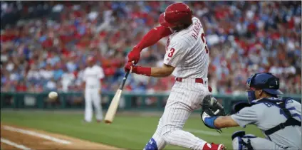  ?? AP PHOTO/MATT SLOCUM ?? Philadelph­ia Phillies’ Bryce Harper (left) hits a three-run home run off Los Angeles Dodgers starting pitcher Walker Buehler during the second inning of a baseball game, on Tuesday, in Philadelph­ia.