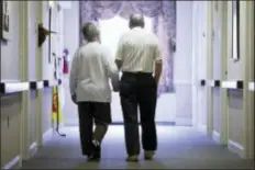  ?? MATT ROURKE — THE ASSOCIATED PRESS FILE ?? In this file photo, an elderly couple walks down a hall in Easton, Pa. It’s not too late to get moving: Simple physical activity, mostly walking, helped high-risk seniors stay mobile after disability-inducing ailments even if, at 70and beyond, they’d...