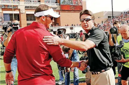  ?? [PHOTO BY STEVE SISNEY, THE OKLAHOMAN] ?? Oklahoma coach Lincoln Riley and Oklahoma State coach Mike Gundy are among the Big 12 coaches who are generally supportive of college football’s new transfer rule.