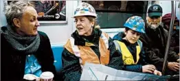  ?? CRAIG RUTTLE/AP ?? Pam Miller and son Ben share a map after leaving one of the new Second Ave. subway stations Sunday in New York.