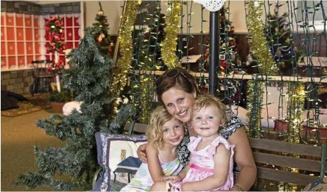  ?? PHOTO: KEVIN FARMER ?? FESTIVE CHEER: Karyn Morgan with daughters Shanae (left) and Teagan Morgan check out last year’s Toowoomba’s Christmas Tree Festival.