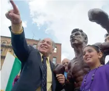  ?? FIle Photo ?? IN THE RING: Ex-welterweig­ht champion Tony DeMarco, left, gestures to the crowd as he stands with his statue in October 2012 just after it was unveiled in the North End.