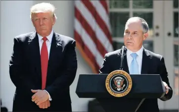  ??  ?? CLIMATE MOVE: President Donald Trump listens as Environmen­tal Protection Agency administra­tor Scott Pruitt speaks about the US role in the Paris climate change accord.