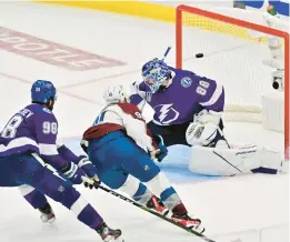  ?? JULIO AGUILAR/GETTY ?? Nazem Kadri (91) of the Colorado Avalanche scores a goal against Andrei Vasilevski­y (88) of the Tampa Bay Lightning to win 3-2 in overtime in Game Four of the 2022 NHL Stanley Cup Final.