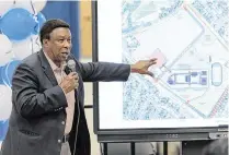  ?? JOSHUA CARTER Belleville News-Democrat ?? Ed Hightower shows a blueprint for the new Cahokia High School during a public meeting at the current high school in Cahokia Heights, Ill., on May 8, 2024.
