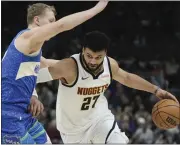  ?? MORRY GASH — THE ASSOCIATED PRESS ?? The Nuggets’ Jamal Murray, right, tries to get past the Bucks’ AJ Green during the first half Monday in Milwaukee.