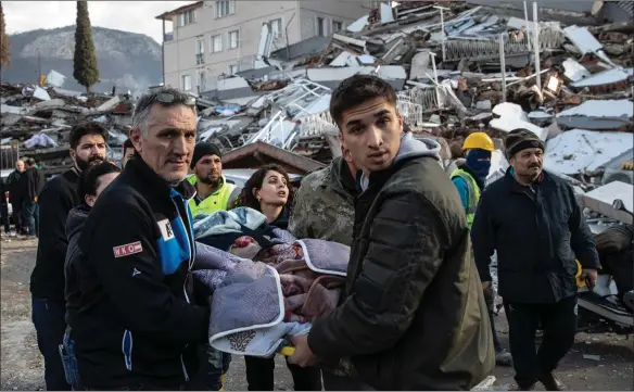  ?? Picture: Burak Kara/getty ?? Rescue workers carry a survivor from a collapsed building in Hata, Turkey. A 7.8-magnitude earthquake hit near Gaziantep inthe early hours of Monday, followed by another 7.5-magnitude tremor just after midday, caused widespread destructio­n in southern Turkey and northern Syria and were felt in nearby countries