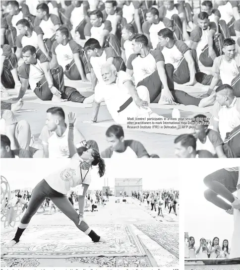  ?? — AFP photo ?? Modi (centre) participat­es in a mass yoga session along with other practition­ers to mark Internatio­nal Yoga Day at the Forest Research Institute (FRI) in Dehradun. — AFP photo People attend a yoga session at the sunrise organised by Nava Yoga Nantes associatio­n at a rooftop in Nantes, western France.