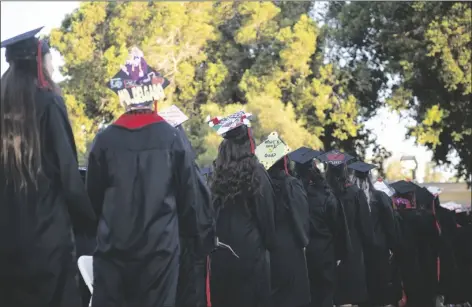  ?? ?? TOP: SDSU-IV students displayed art in their graduation caps Thursday in Calexico.