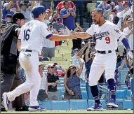  ?? AP/ALEX GALLARDO ?? Will Smith (9) of the Los Angeles Dodgers is congratula­ted by teammate Kristopher Negron after scoring the game-winning run on a two-run single by Russell Martin in the ninth inning Wednesday against the St. Louis Cardinals.