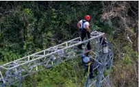  ?? ASSOCIATED PRESS FILE PHOTO ?? Whitefish Energy Holdings workers restore power lines damaged by Hurricane Maria on Oct. 15 in Barcelonet­a, Puerto Rico. The head of Puerto Rico’s power company announced Sunday that its $300 million contract with Whitefish will be canceled.